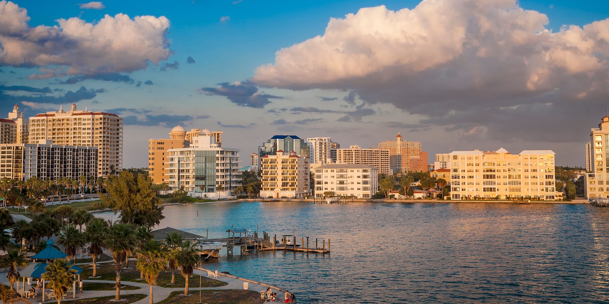 Sarasota waterfront, Florida skyline with quote that reads "Invested in the Business Community"